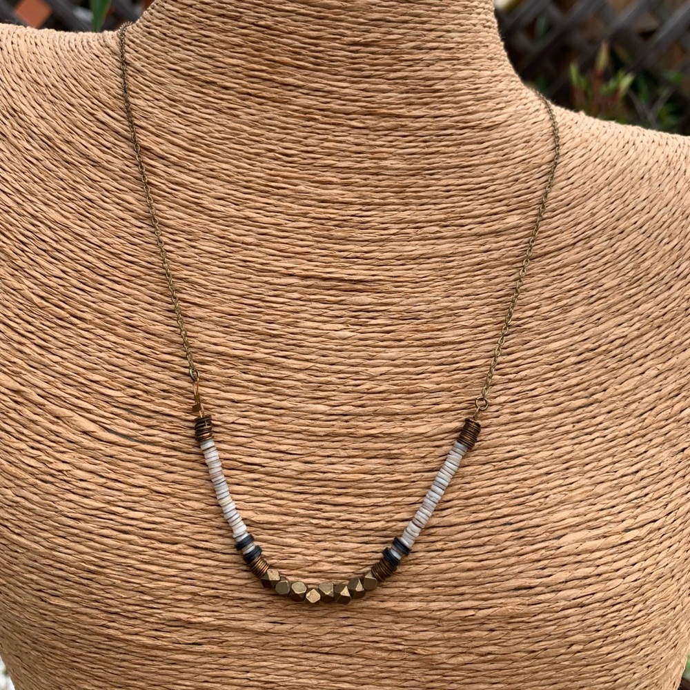 Puka shells and brass necklace